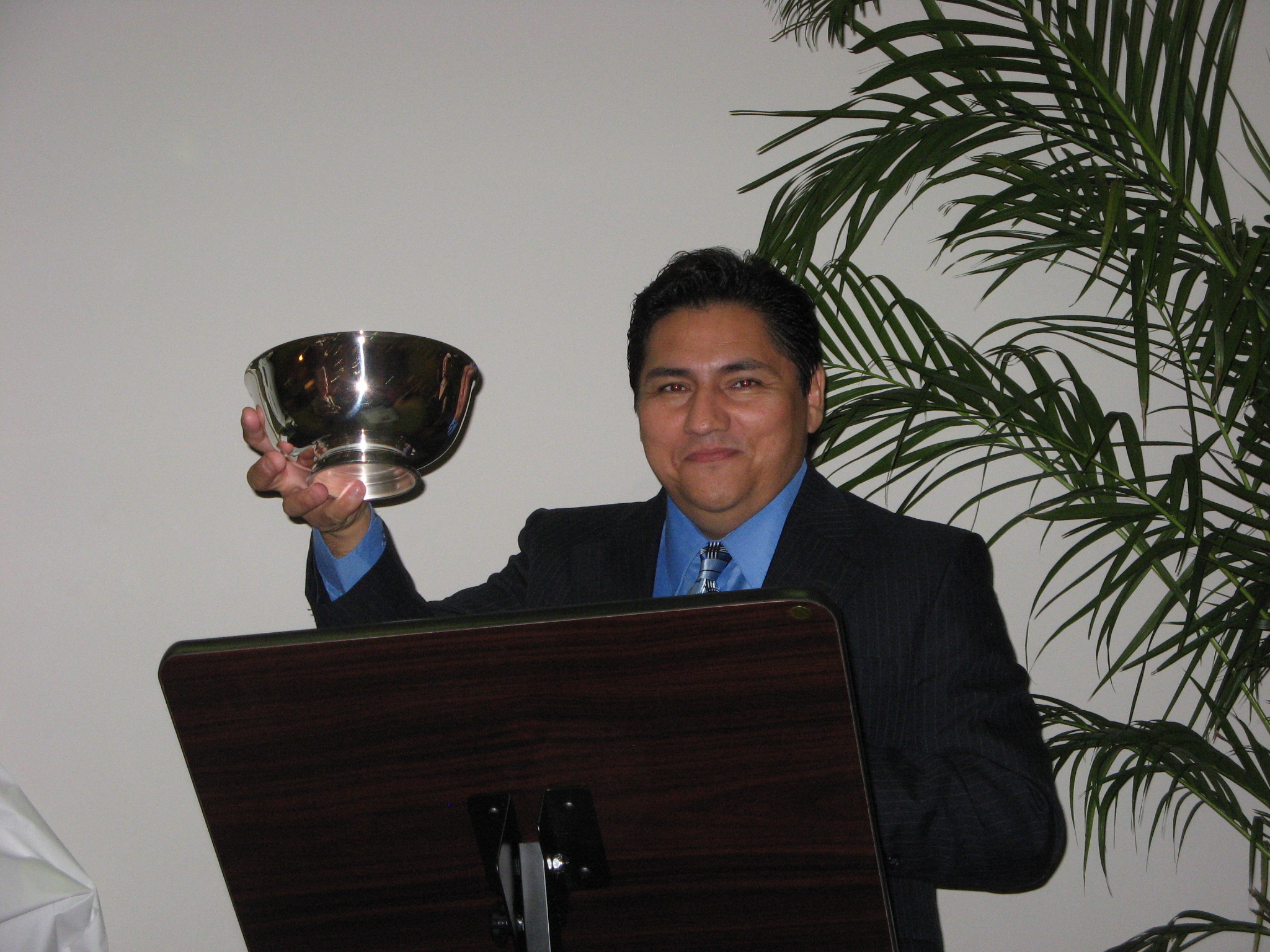 David Gallegos holding a silver bowl award