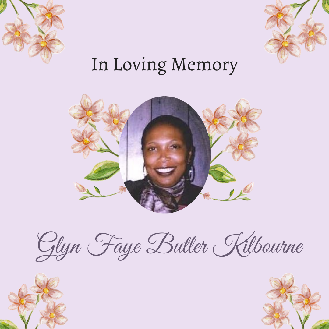 Text reads “In loving memory. Glyn Faye Butler Kilbourne” framing a picture of Glyn Faye Butler Kilbourne, an African-American woman wearing a purple scarf over a black top and smiling, over a purple background decorated with a pattern of flowers.